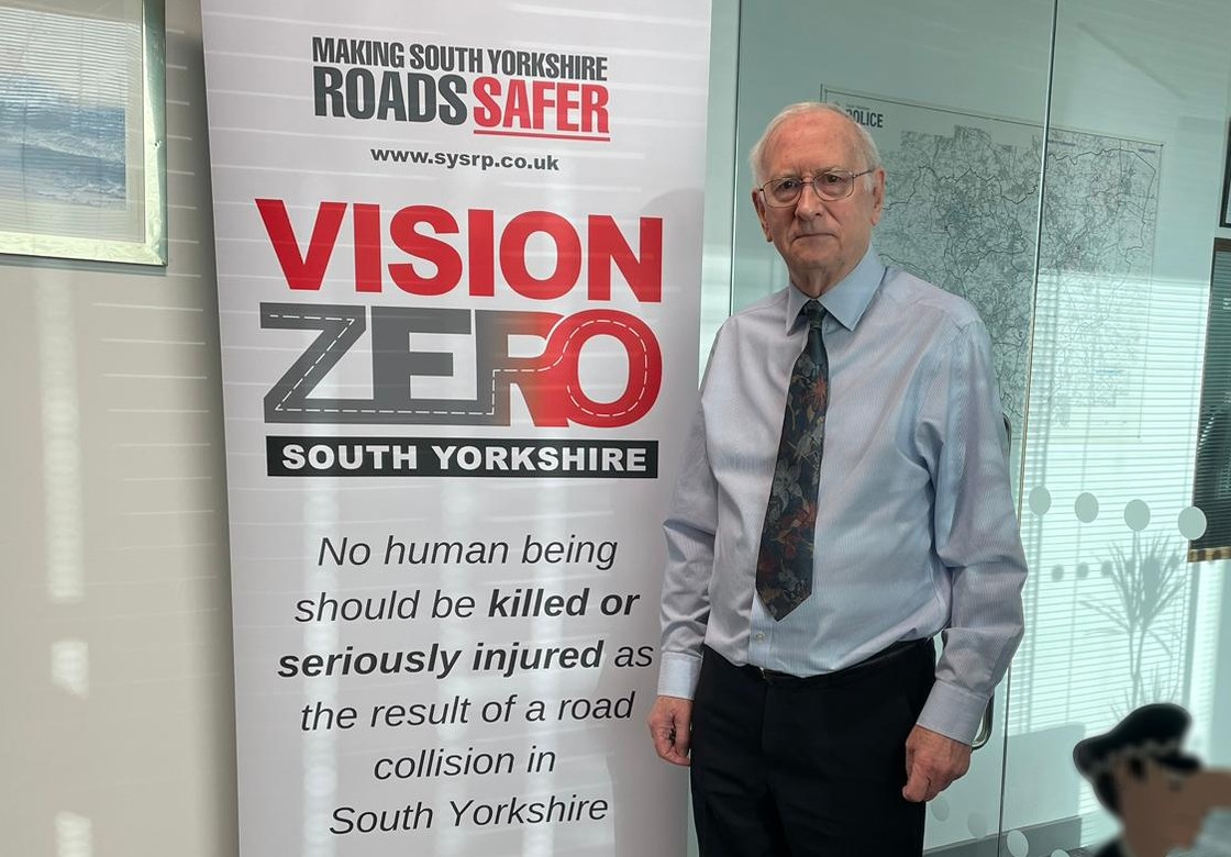 Dr Billings stood next to a Vision Zero banner